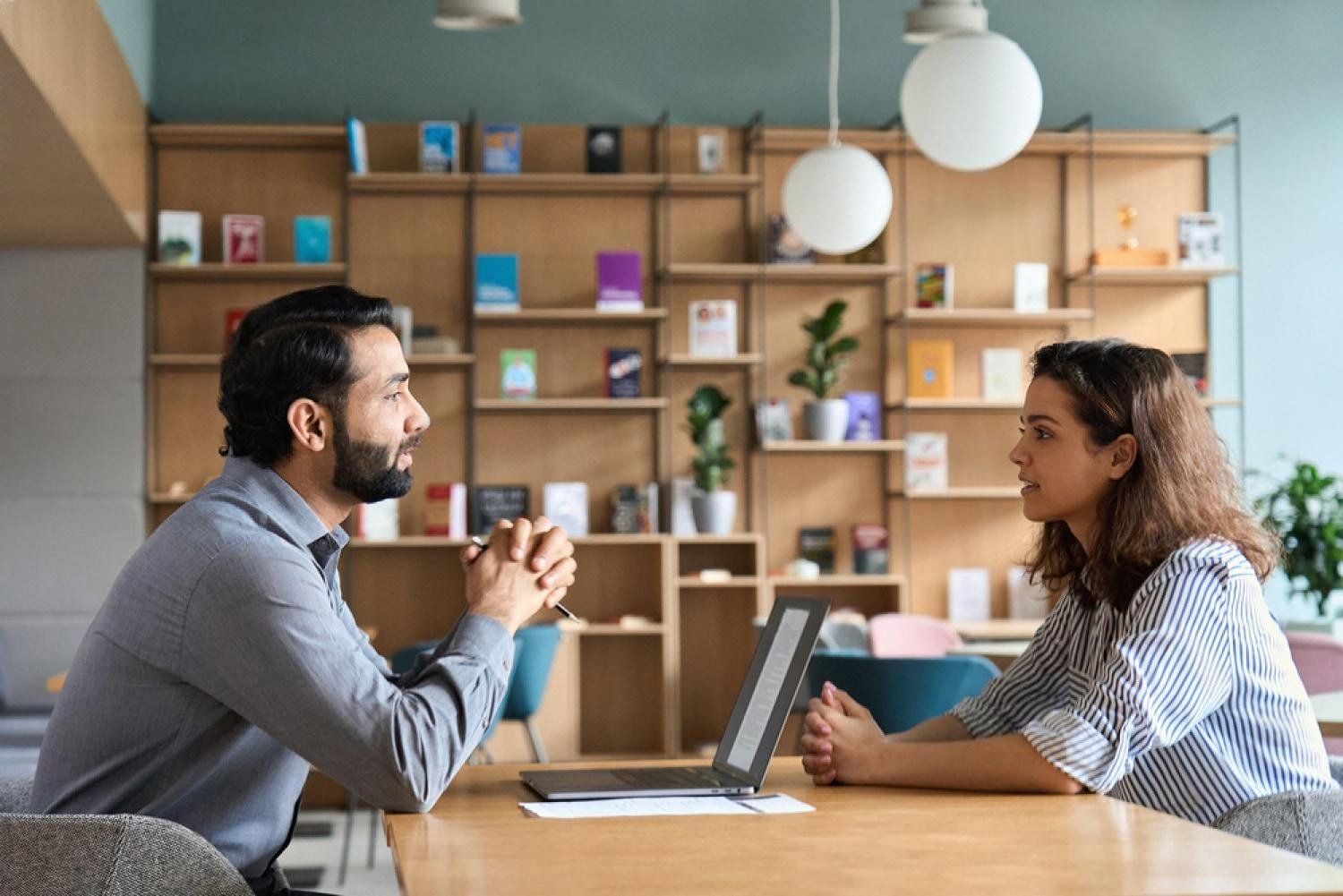 HR consultant interviewing an employee in a modern UAE office